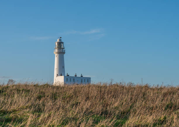 The Lighthouse at Flamborough Head a white building on a sunny day with blue sky background