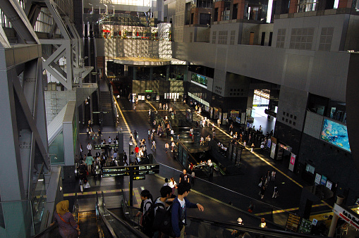 A crowd of people walking and passing by at a shopping mall in Kyoto, Japan. The picture was taken from above