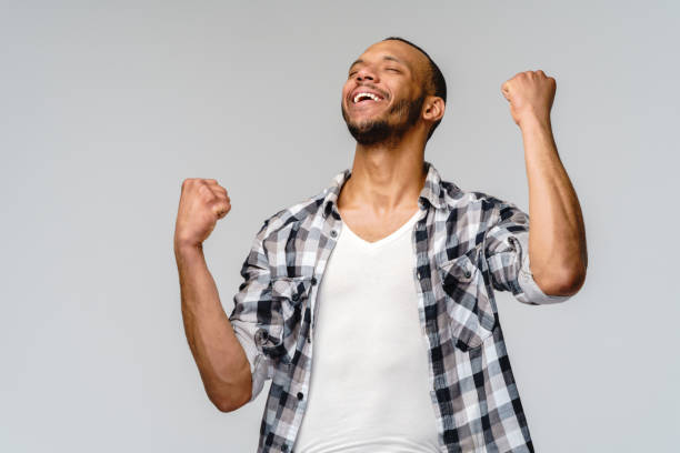 istock Young African-American man yes win gesturing over light grey background 1291570393