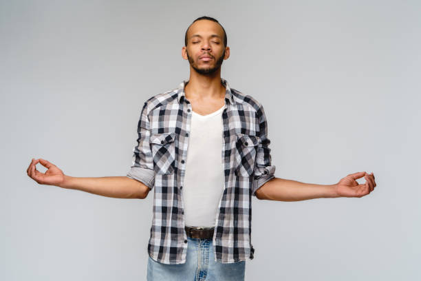 istock studio shot of young man in meditation 1291570434
