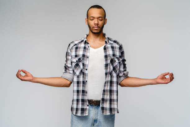 istock studio shot of young man in meditation 1291570439
