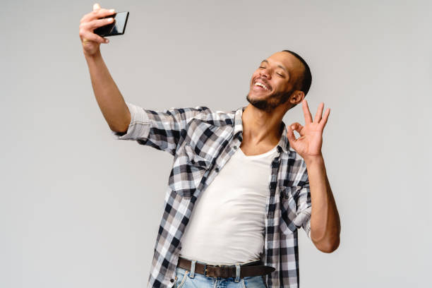 istock Happy african american man using mobile phone for video call 1291570584
