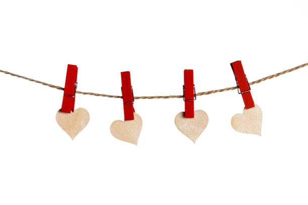 istock Clothes pegs and red paper hearts 1291572474