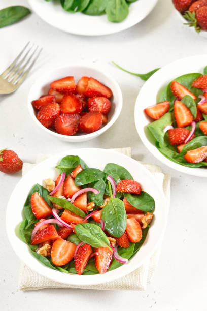 istock Healthy breakfast with fruit salad from strawberry, spinach and walnut 1291572811