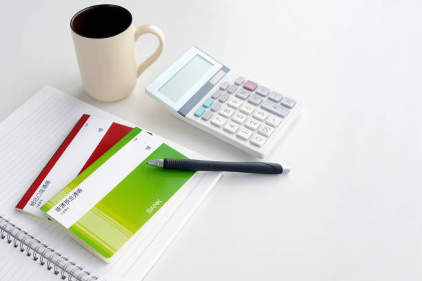 istock Japanese passbook and calculator on table 1291573884
