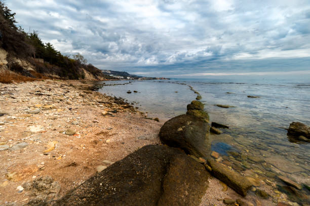 Dramatic sky at the Black Sea shore near Balchik's Tuzla place. White Lagoon resort in the distance. Bulgaria, Europe.