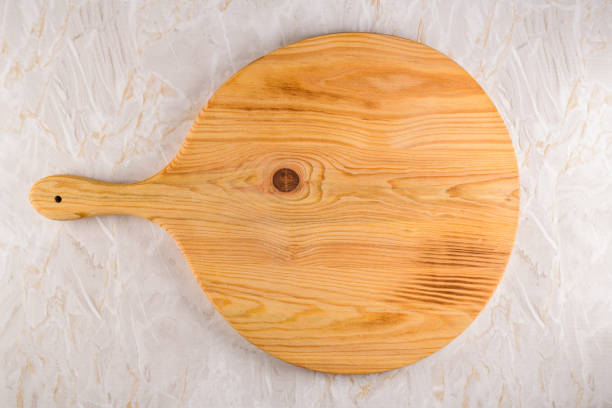 istock Wooden cutting board on a gray marble background 1291577167