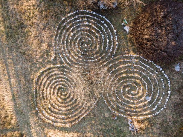 istock Triskellion Maze Made From Stones on a Meadow From Directly Above 1291577503