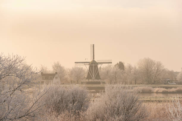 View on an old windmill in the city of Kampen next to the river IJssel in winter in Holland. Kampen is an ancient Hanseatic League in Overijssel, The Netherlands.