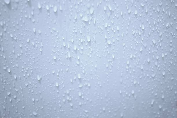 istock Blurred many water droplets on white bathroom wall with soft light for background backdrop 1291578395