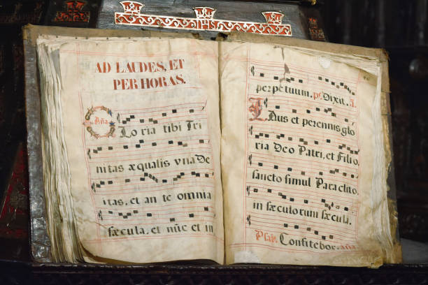 Ancient codex book written in Latin with musical score of Gregorian singing, Ad laudes, et per horas. At Astorga Cathedral, Spain Ancient codex book written in Latin with musical score of Gregorian chant, Ad laudes, et per horas. In the Cathedral of Astorga, Spain chanting stock pictures, royalty-free photos & images
