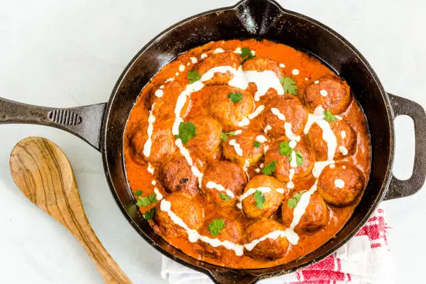 Chicken Meatballs in a Skillet, Butter Chicken Meatballs Top Down Photo on White Background
