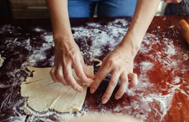 istock A woman in the kitchen creates homemade dough. Classes during self-isolation or quarantine. Hands and flour close up. Making cookies or pizza. Home comfort and cooking concept. 1291582449