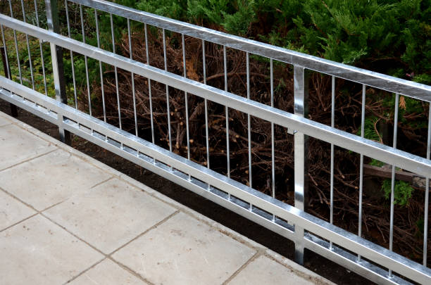 istock railing with two handrails. made of galvanized steel prisms. the lower railing is a protection against wheelchairs. ramp for the immobile in the housing estate 1291582621