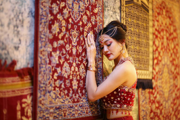 istock Young Woman In Traditional Clothing Standing By Patterned Wall 1291582728