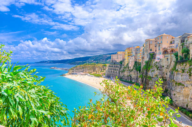 Tropea town and beach, Tyrrhenian Sea turquoise water, colorful buildings on top of high big rocks cliffs stock photo