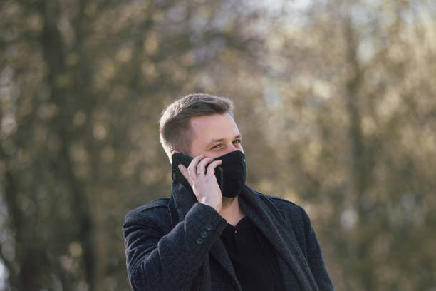 istock Masked man walking in the park 1291585889