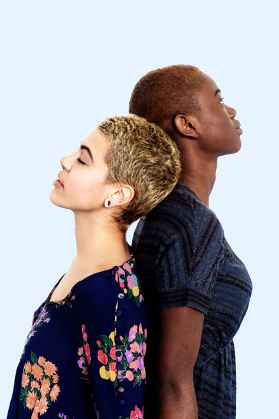 istock Two diverse women standing back to back in studio 1291586590
