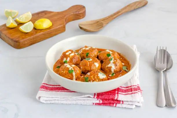 Chicken Meatballs in a Bowl, Butter Chicken Meatballs Top Down Photo on White Background