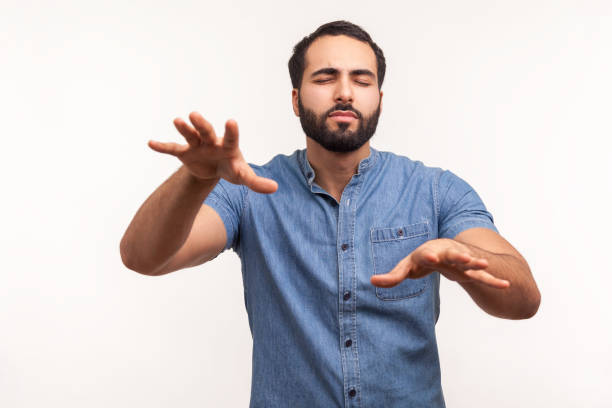 istock Disoriented bearded man moving with closed eyes, touching space with hands, confused with darkness, vision problems, eyesight disorder 1291589121
