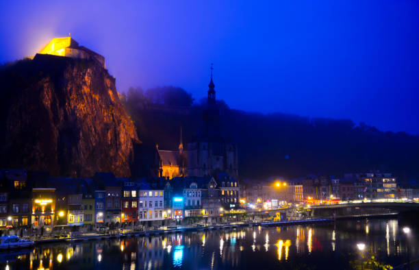 istock Small Belgian town Dinant on Meuse river in Walloon, Belgium at night 1291589583