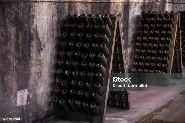 Champagne Sparkling Wine Production In Bottles In Racks In Underground Cellar Reims Champagne France Stock Photo - Download Image Now