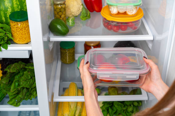 istock Female hands taking storage box with food from a fridge 1291589829