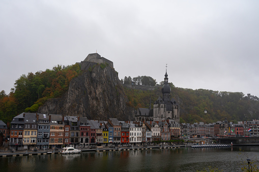 View on buildings on rainy day in small Belgian town Dinant on Meuse river in Walloon, Belgium