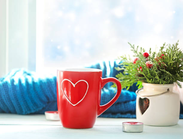 istock Winter concept,mug on window sill,christmas decorations empty copy space.Valentines day banner. 1291591442