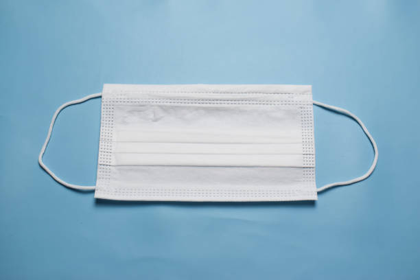 istock White Medical Face Mask On Blue Background 1291591898