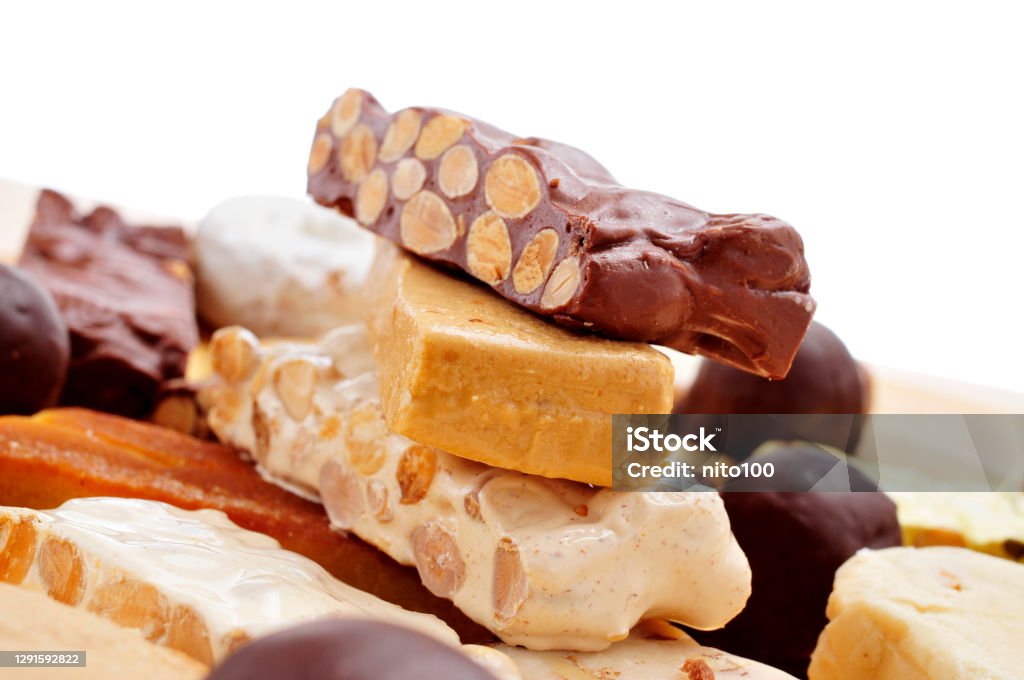 turron, typical christmas sweet food in Spain closeup of a tray with pieces of different turron, typical christmas sweet food in Spain Nougat Stock Photo