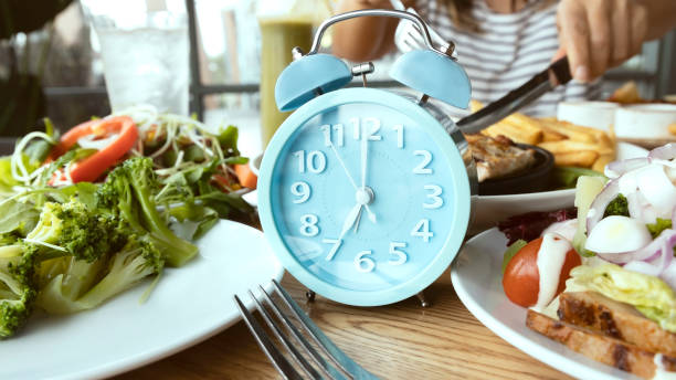 istock Selective focus of 07. 00 AM clock and breakfast time, Alarm clock intermittent fasting as a healthy and balanced breakfast 1291593783