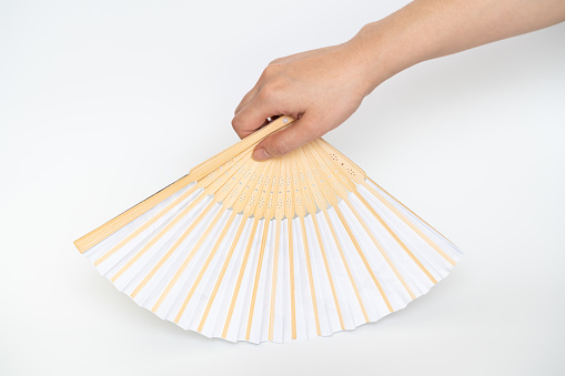 Isolated woman hand holding asian folding fan