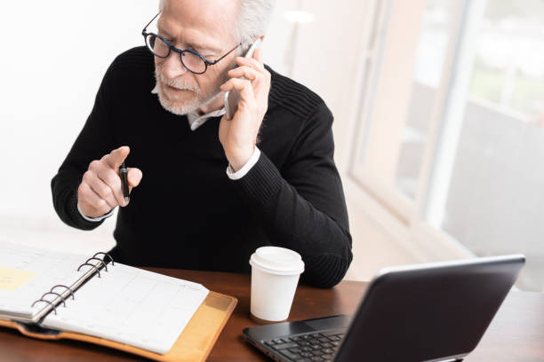 istock Businessman talking on mobile phone to make an appointment 1291600146