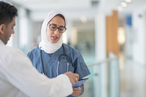 istock Middle eastern female nursing talking to doctor 1291600284