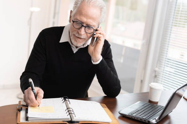 istock Businessman talking on mobile phone to make an appointment 1291600443