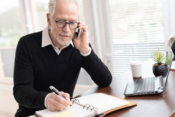 istock Businessman talking on mobile phone to make an appointment 1291600457