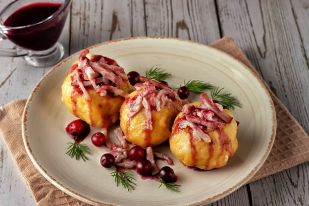 Swedish potato dumplings with cranberry sauce on a light background