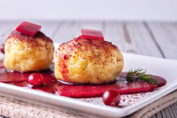 istock Swedish potato dumplings with cranberry sauce on a light background 1291602852