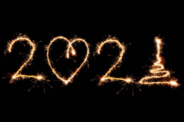 istock 2021 written with Sparkle firework on black background, happy new year 1291604266