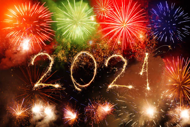istock 2021 Happy New Year written with Sparkle firework on black background 1291604425