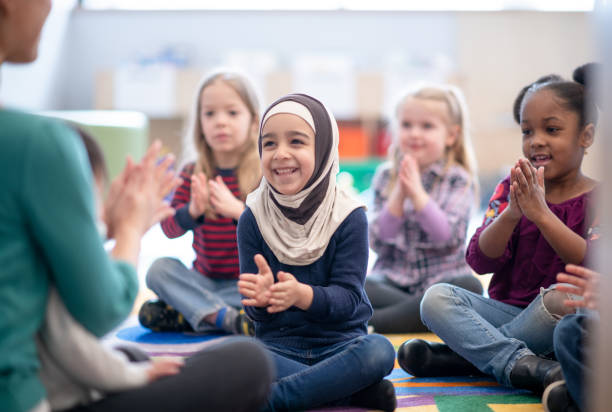 istock Preschool children clapping hands at library 1291604677
