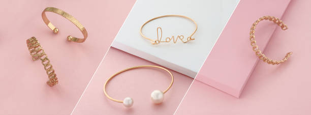 Modern golden bracelets on pink and white slanted layout Modern golden bracelets on pink and white background ring tilt stock pictures, royalty-free photos & images