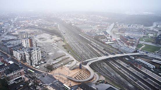 Train station and tracks in Odense. There has been build an elevated walkway over the tracks, Gray and overcast morning in Odense