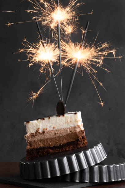 istock Piece of cake with sparkle lights, festive celebration concept 1291604985