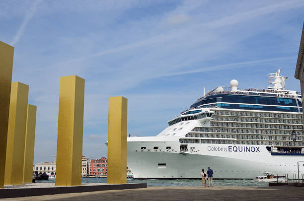 Cruise ship in Venetian Lagoon, Venice, Italy Venice, Italy- Sept 24, 2014: The cruise ship Celebrity Equinox crosses the Venetian Lagoon at morning. More than 10 million tourists visit Venice every year high tide stock pictures, royalty-free photos & images