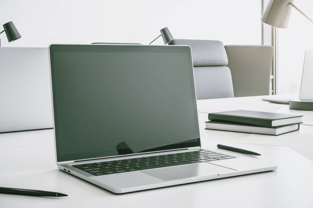 istock Modern laptop with blank screen on white table in a contemporary office, mock up. 3D Rendering 1291606230