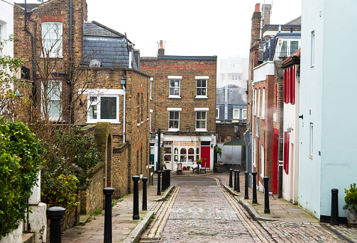 Color image depicting typical row houses on a residential street in the affluent area of Hampstead in London, UK.