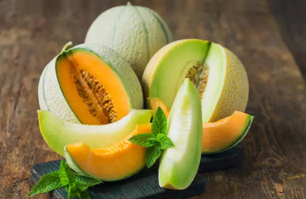 Fresh ripe melons on the wooden table