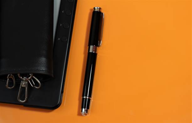 istock business background with electronic book with pen 1291607724
